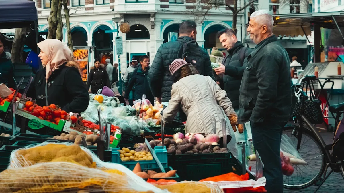 Shoppers browsing a busy outdoor farmers market with colorful produce displayed in crates and bins on a city street